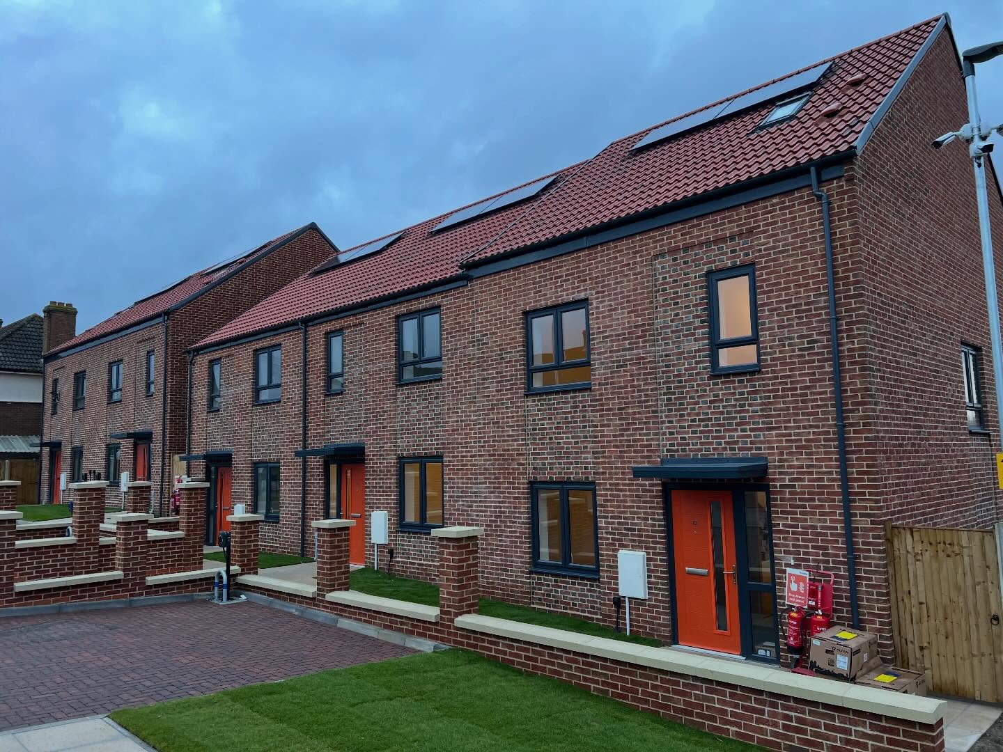 New brick homes with orange entrance doors